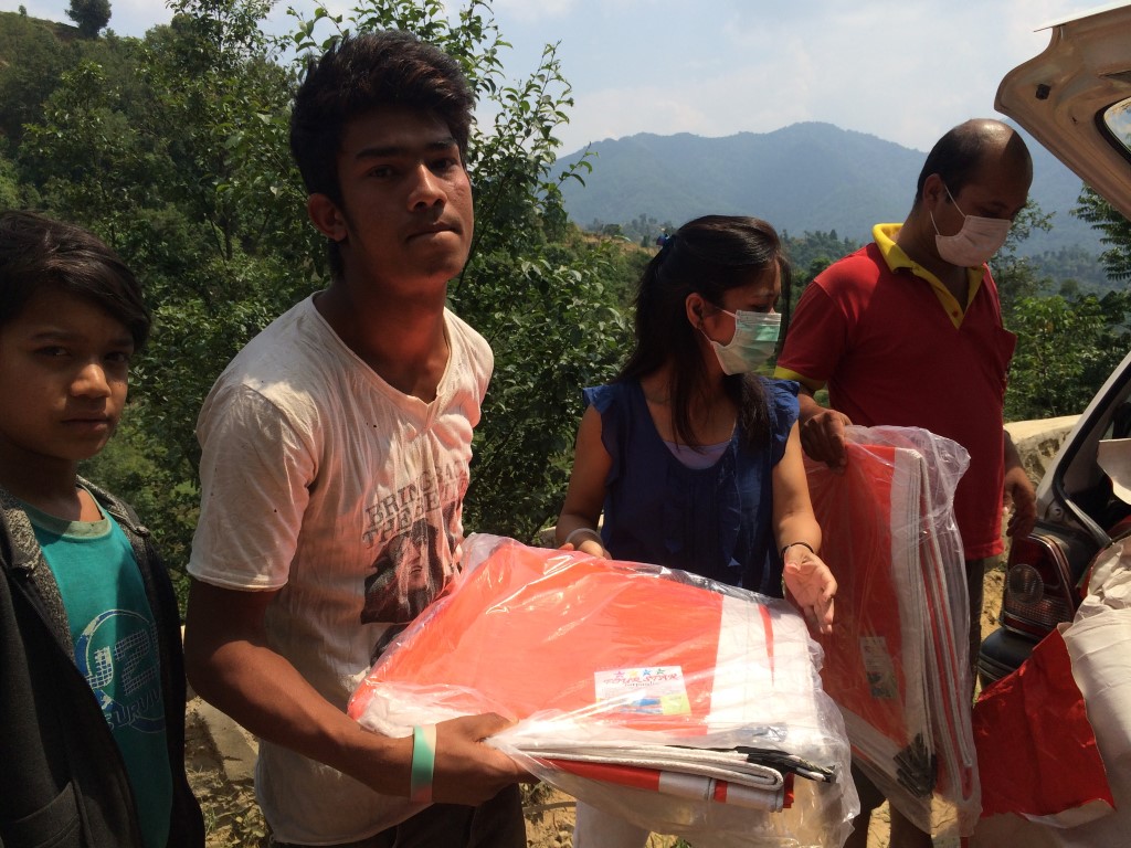 Victim receiving Trapaulin as immediate relief support