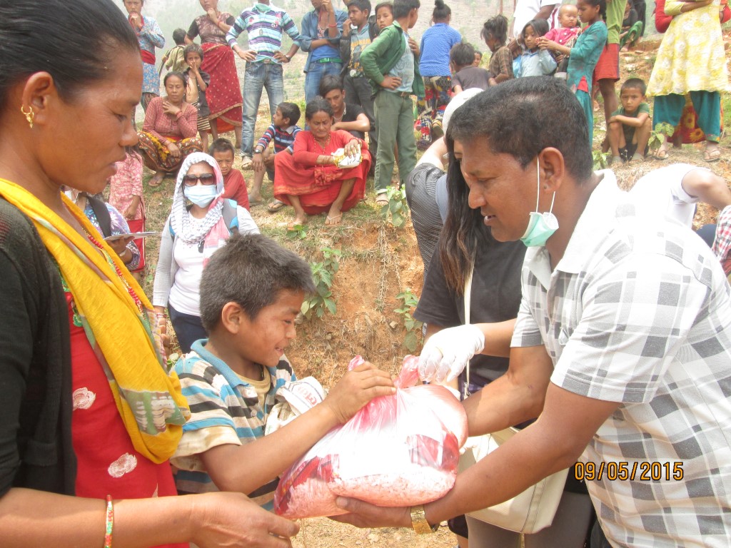 Volunteer distributing immediate relief items at Haldekalika, Nuwakot
